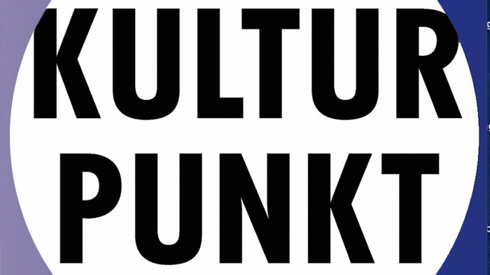 Logo mit fett gedrucktem Text „KULTUR PUNKT“ in einem weißen Kreis auf violettem Hintergrund.