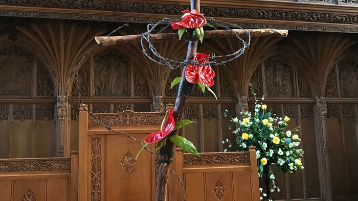 Cross-shaped flower arrangement in church