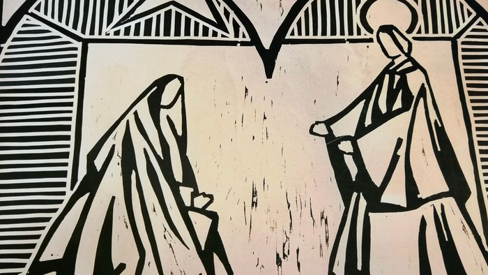 Das Bild zeigt eine schwarz-weiße Holzschnittdarstellung der Heiligen Familie vor einem Stern.