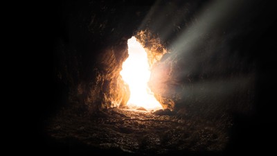 Empty tomb with light shining through, symbolizing resurrection