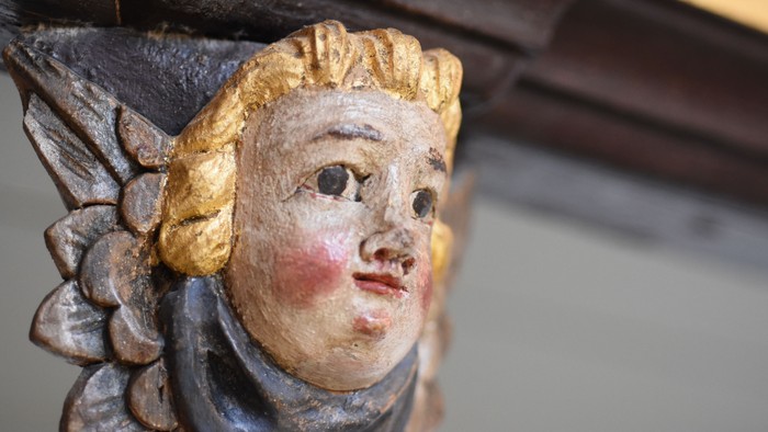 En smuk udskåret figur af en kvinde med gyldne hår og blå øjne.