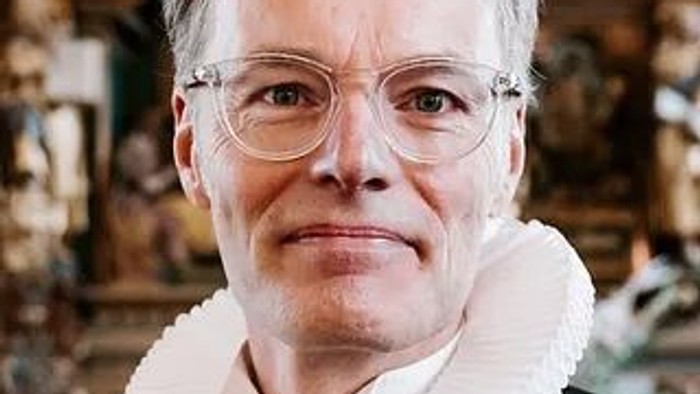 Kvinde med briller og hvid krave.