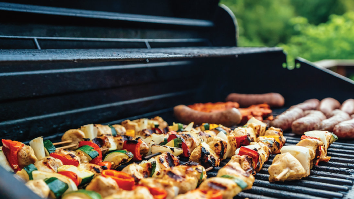 Grillen mit Fleischspießen und Würstchen auf einem Holzkohlegrill