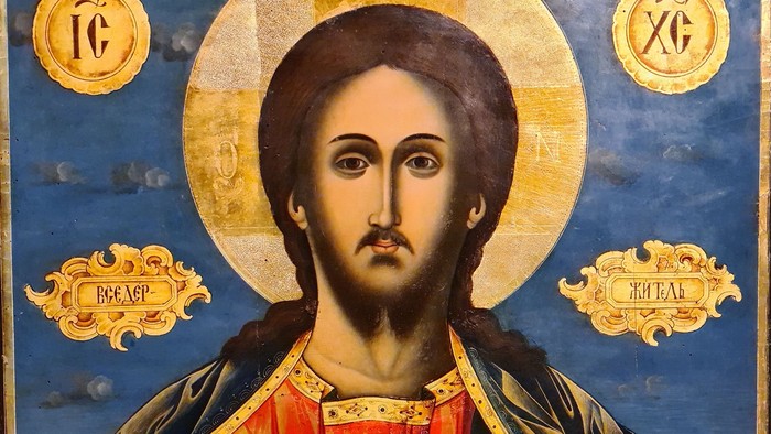 Ikonisk religiøst portræt af Kristus Pantokrator med gylden glorie og traditionel byzantinsk stil.