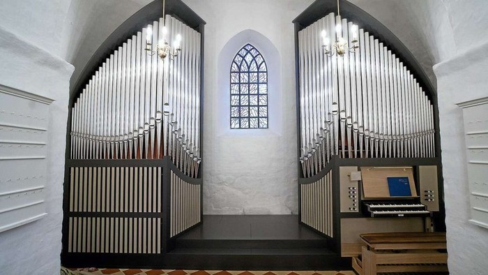 Kirkeinteriør med pibeorgel og farvet glasvindue