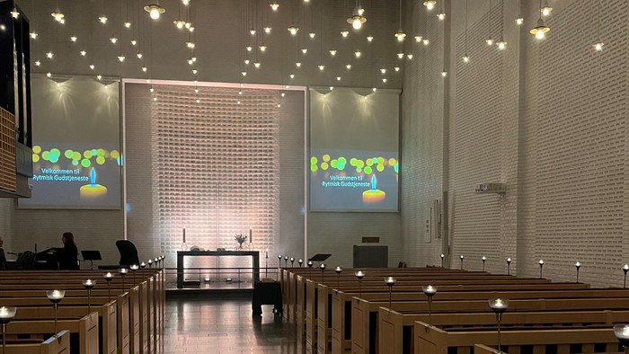 Indre del af kirke med lys og skærme