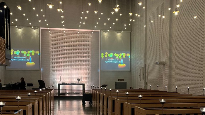 Indre del af kirke med lys og skærme