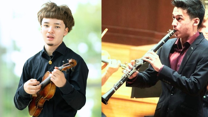 Zwei Musiker, die während einer Aufführung Geige und Oboe spielen.