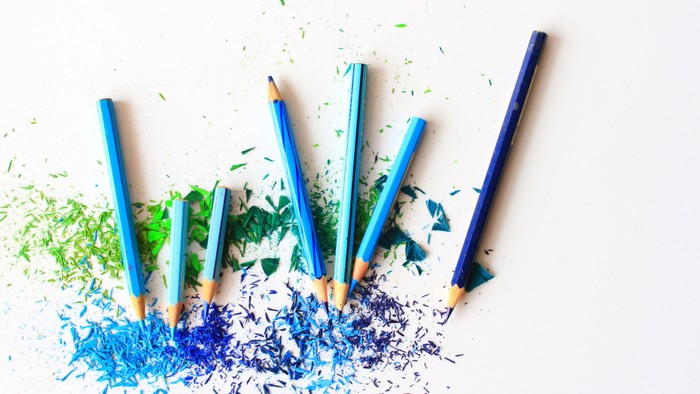 Buntstifte mit Spänen in Blau- und Grüntönen.