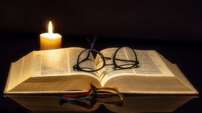Bibel mit Brille und Kerze