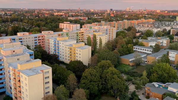 Stadtansicht bei Sonnenuntergang mit Wohngebäuden und Bäumen