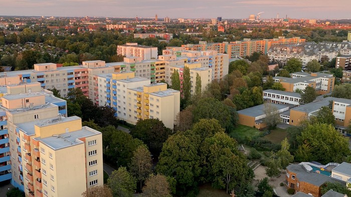 Stadtansicht bei Sonnenuntergang mit Wohngebäuden und Bäumen