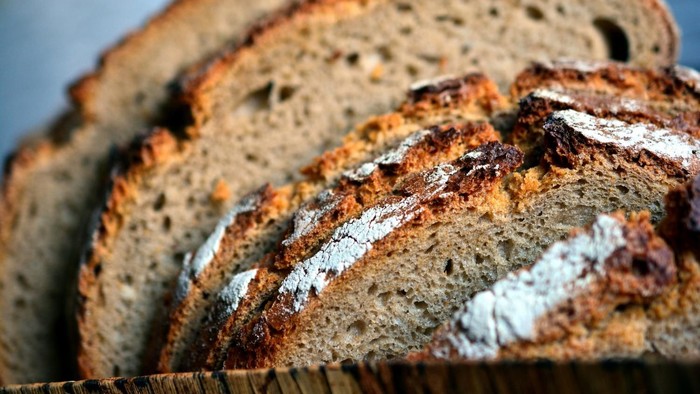 Frisch geschnittenes rustikales Vollkornbrot mit sichtbaren Körnern und knuspriger Röstkruste.