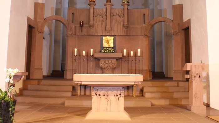 Die Kirche mit Altar, Kreuz und farbigem Fenster