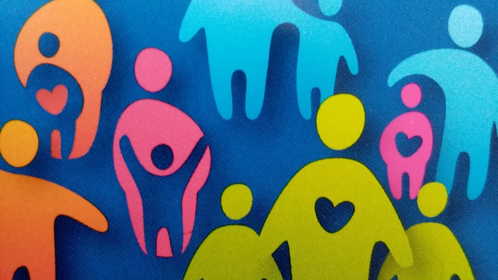 Bunte Figuren stehen in einer Gruppe zusammen