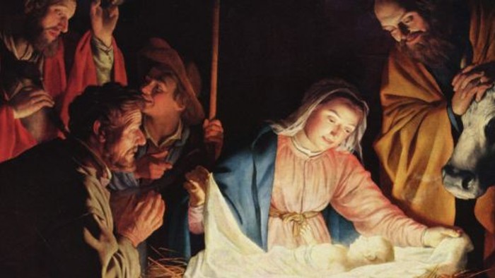 En gruppe mennesker samlet sig omkring en kvinde, der holder en baby, sandsynligvis som en afbildning af en religiøs scene.