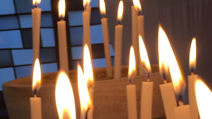 In Erinnerung an Verstorbene brennen zahlreiche Kerzen.
