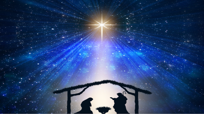 Umriss einer Weihnachtskrippe mit strahlendem Stern darüber, vor sternenklarer Nachthimmelkulisse.