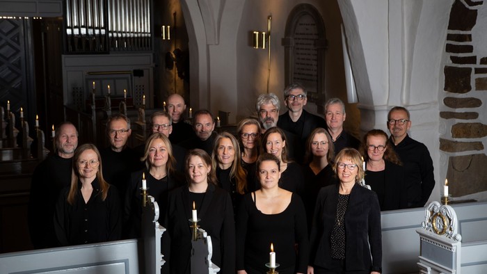 En gruppe af mænd og kvinder poserer sammen i en kirke.