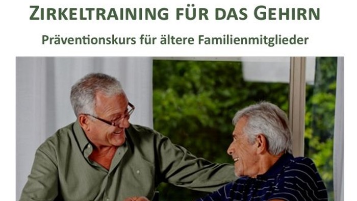 Zwei ältere Männer sitzen an einem Tisch und lachen, während sie etwas auf einem Stück Papier betrachten.