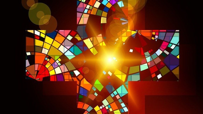 Buntes Mosaikkreuz vor dunklem Hintergrund