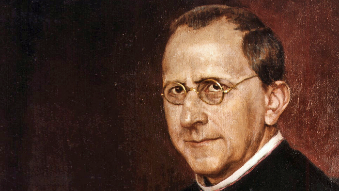 Ein älterer Mann mit Brille und dunklem Anzug.