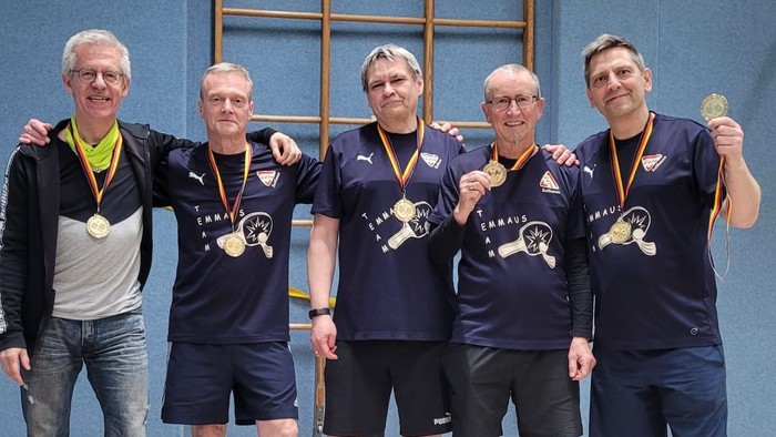 Zu sehen sind 5 Männer der Tischtennisgruppe der Emmaus-Kirchengemeinde, die stolz ihre Medaillen präsentieren nach dem Sieg der CVJM Hobbyliga.