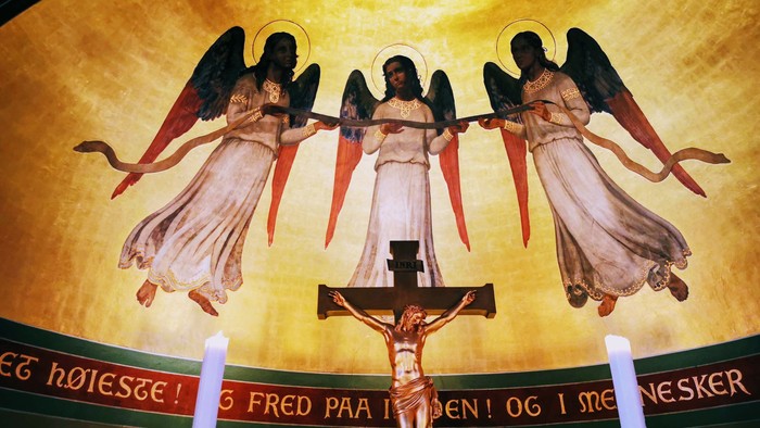 To angels omgivet af lys og kors med Jesus