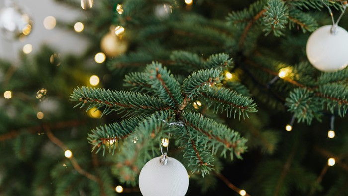 Juletræ pyntet med hvide julekugler og lys