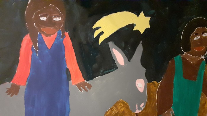 Ein Kind reitet auf einem Esel, während zwei weitere Kinder daneben gehen