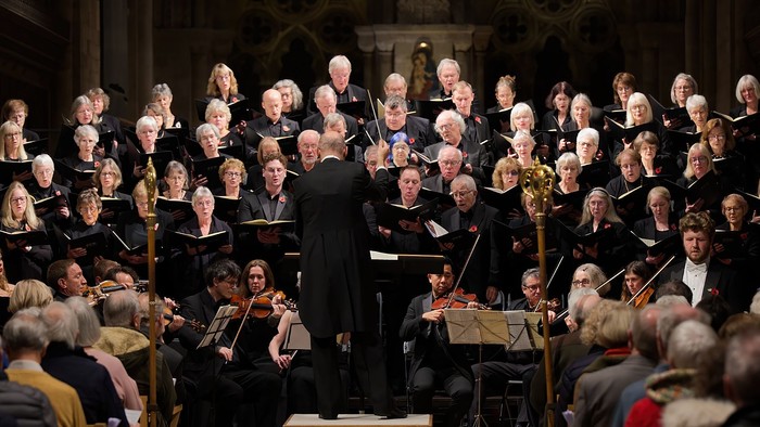 Large choir and orchestra performing in grand hall