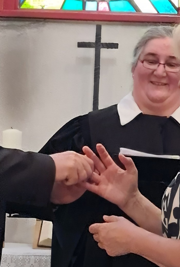 Michaela Frischholz freut sich, während das Paar im Zuge seiner Segnung die Ringe tauscht. (Foto: Klaus Kordesch /eöa)