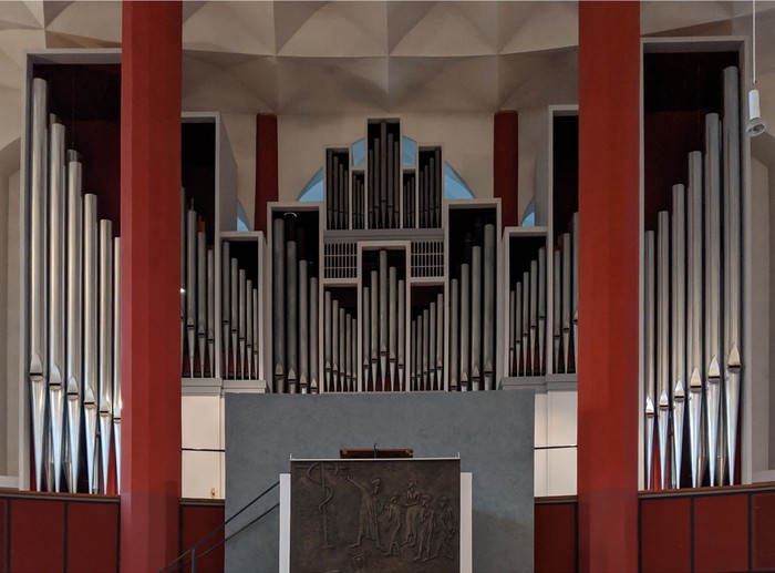 Orgel in Kirche mit farbenfrohem Gehäuse und Relief