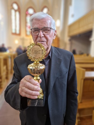 Reinhold Linder mit einem Ehrungspokal in der Hand